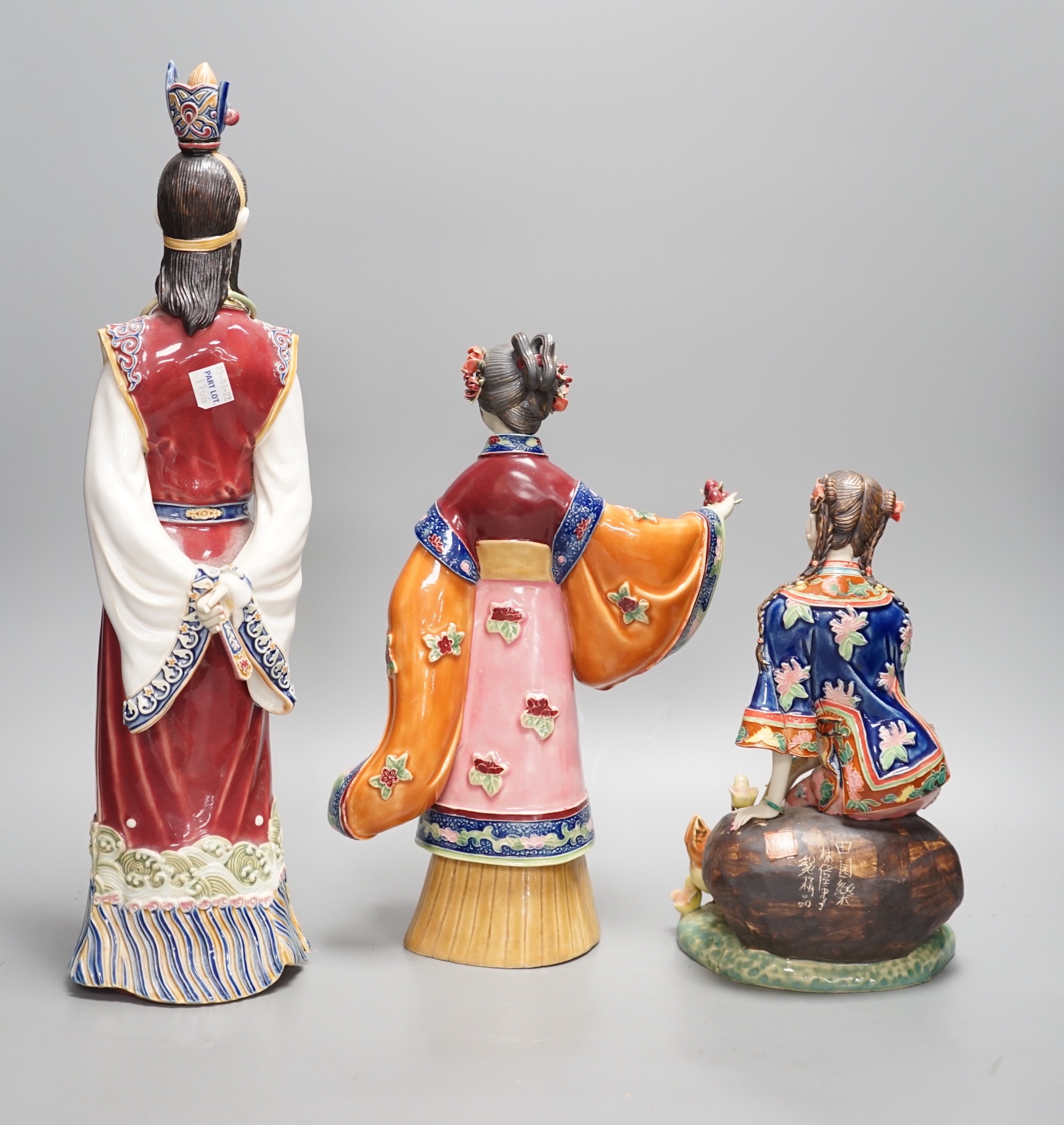 Three Chinese pottery figures, one signed, tallest 42cm